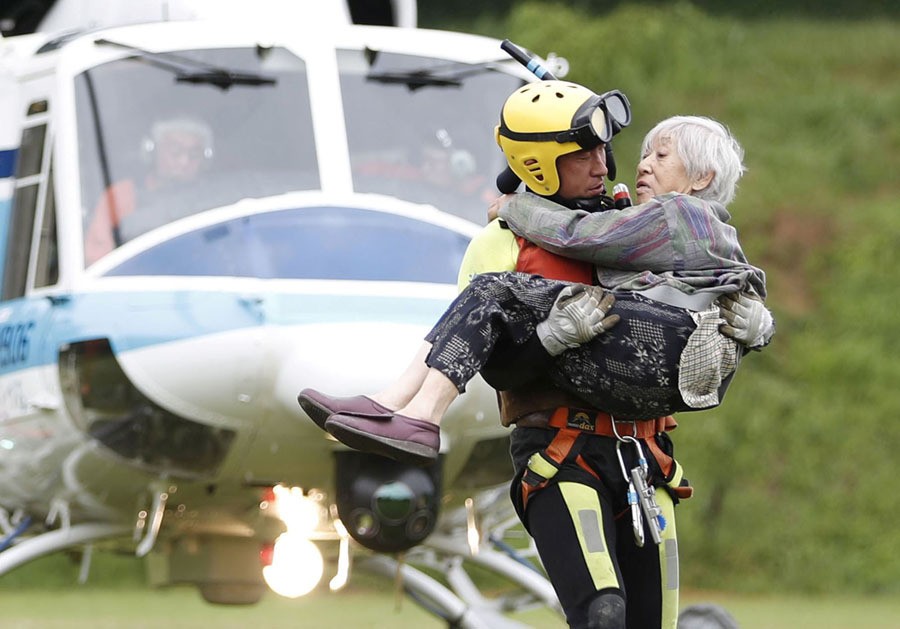 People who were stranded and rescued by a helicopter following heavy rain in southwestern Japan arrive in the city of Asakura, Fukuoka Prefecture, Japan, on July 7, 2017.