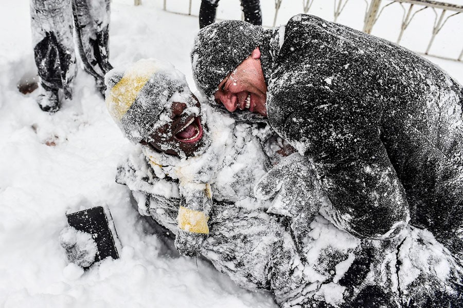 People play in the snow at Taksim Square during snowfall in Istanbul on January 7, 2017.