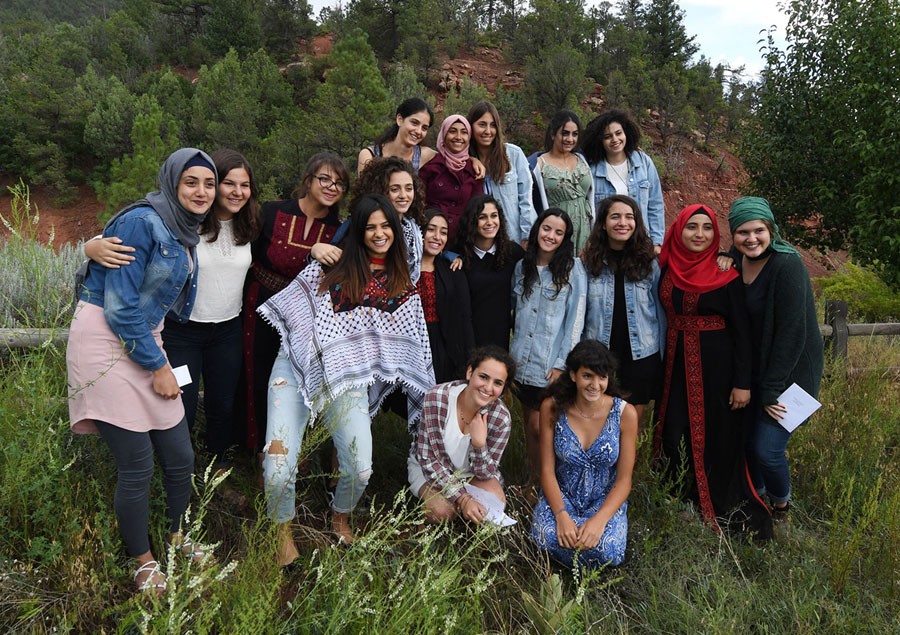 Palestinian and Israeli Jewish girls take a group photo together at the "Creativity for Peace" camp on July 30, 2017, which every year brings up to 20 girls—half Jewish Israelis and half Palestinians from Israel, the West Bank, and Gaza—to Santa Fe, New Mexico. The girls share their experiences of the Arab-Israeli conflict as part of a total of 40 hours of dialogue founded on the notion that "an enemy is a person whose story you haven't heard." Using English as their common language, they go shopping, visit the movies, divvy up chores, share bedrooms, and attend art therapy classes together.