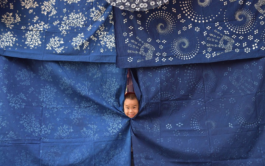 A child plays at a dye workshop in Shaoyang, Hunan province, China, on July 18, 2017.