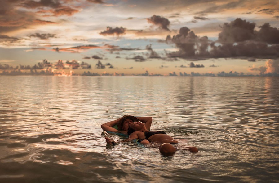 A couple floats in the water on a beach at the Tumon bay area of Guam on August 13, 2017.