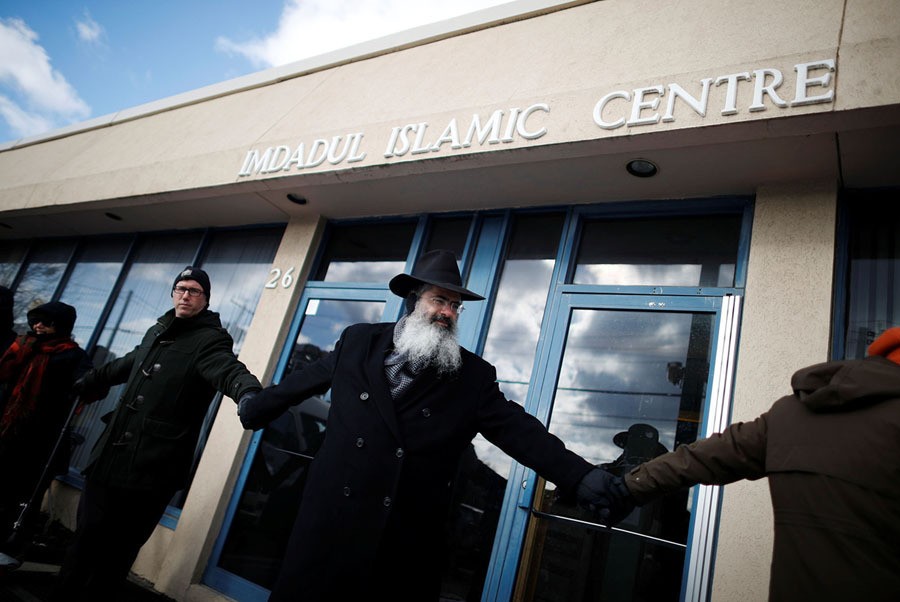 People from the Holy Blossom Temple Synagogue and the Fairlawn United Church form a "Ring of Peace" outside The Imdadul Islamic Centre, during prayers, to show solidarity in condemning the deadly January 29 shooting at the Quebec Islamic Cultural Centre, in Toronto, Ontario, Canada, on February 3, 2017.