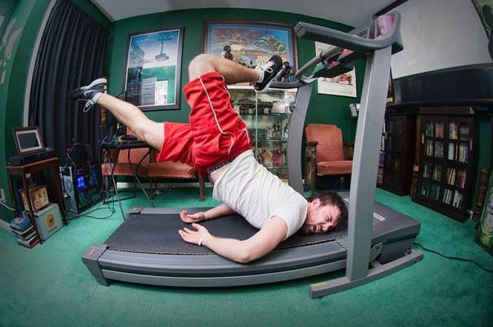 perfect timing picture of man falling head first onto his treadmill