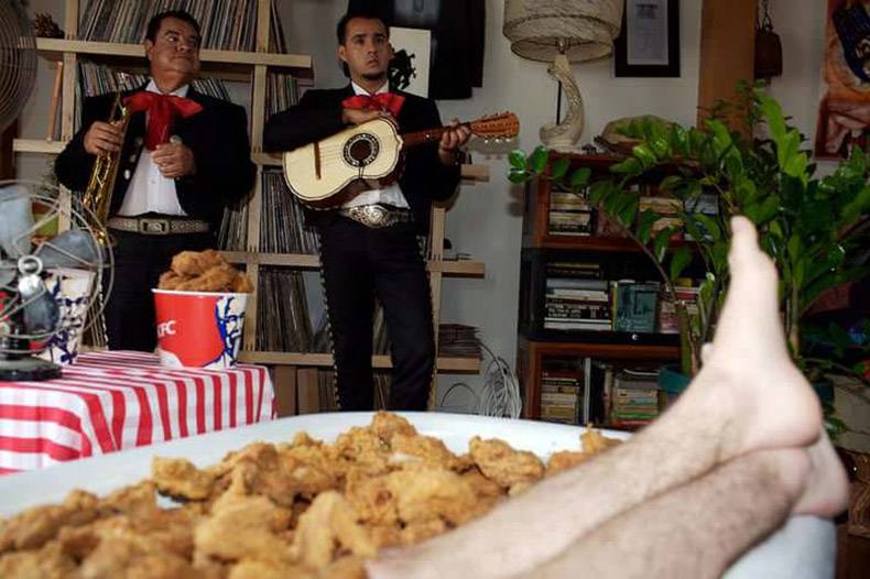mariachi band playing for someone soaking in tub full of KFC