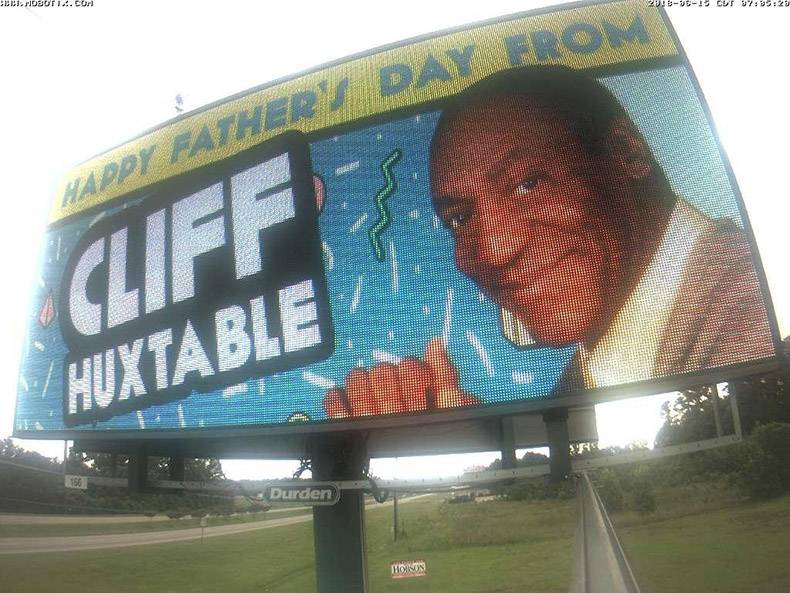 happy fathers day from cliff huxtable on a billboard sign