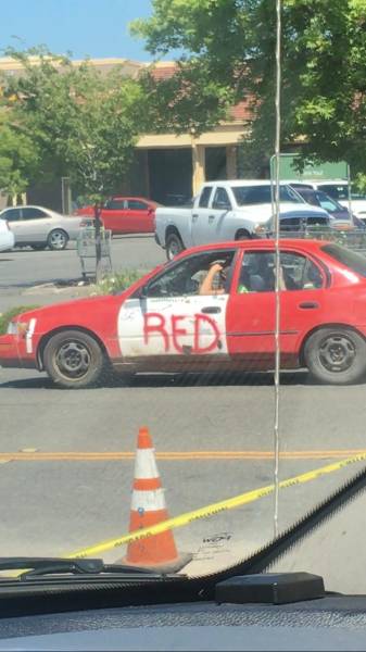 red car with white door written RED on it