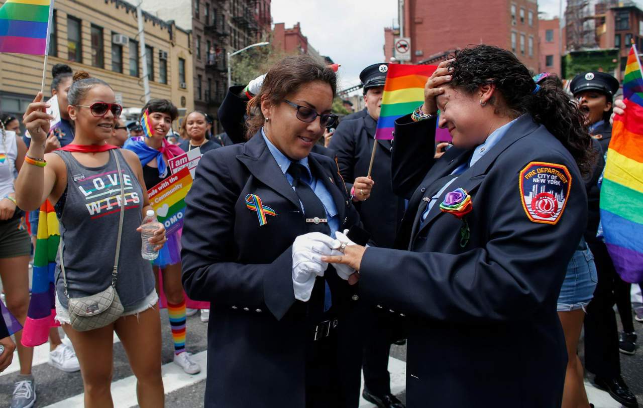 Police women getting engaged at LGBT gathering