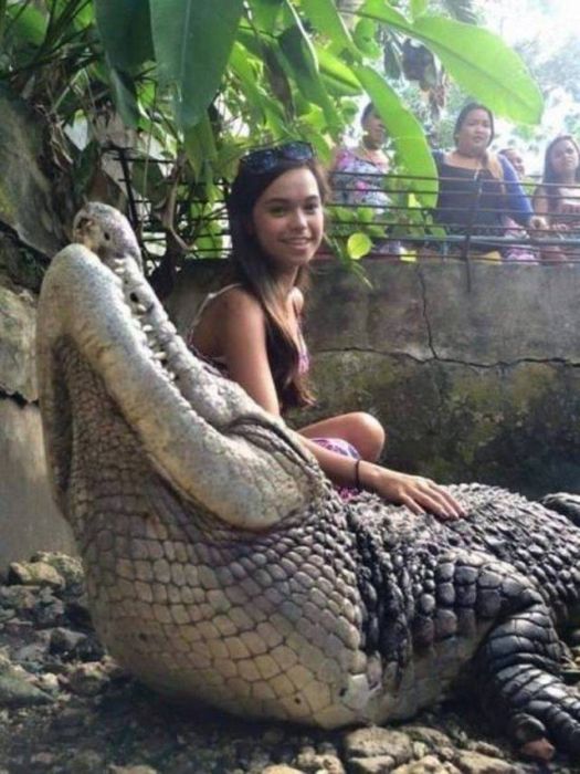 woman holding a crocodile
