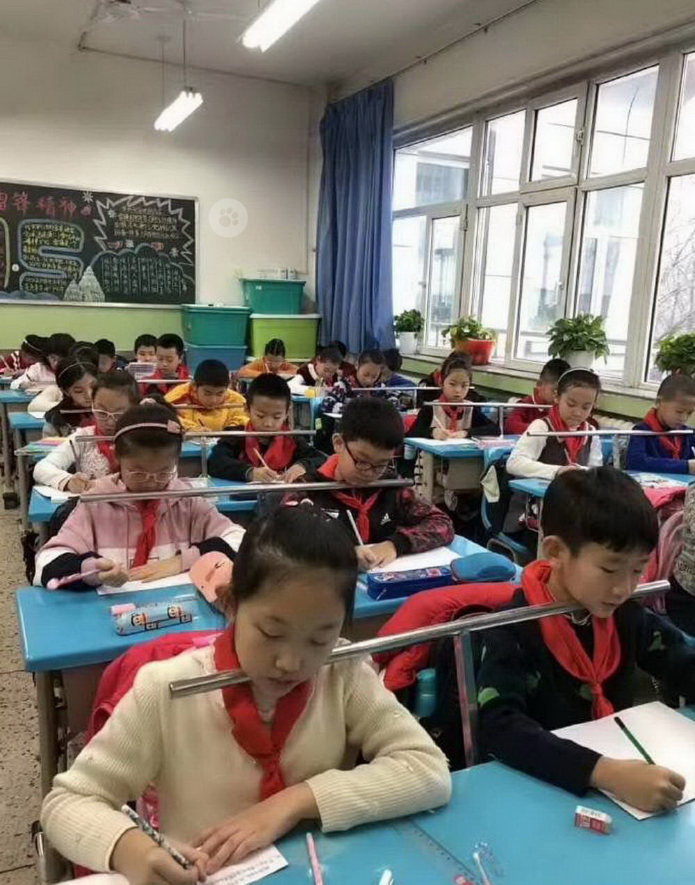 remarkable image of children having their heads kept straight while writing