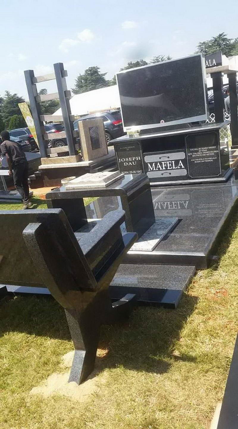 cool pic of a tomb shaped like a couch and a tv set