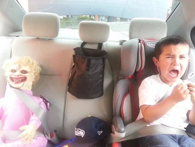 Kid screaming in the backseat next to a scary doll