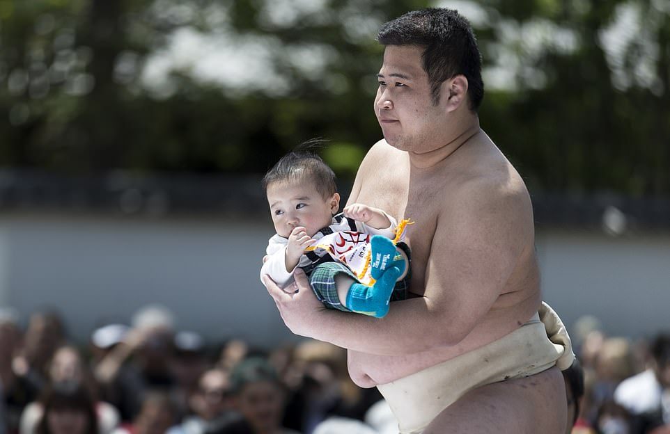 Sumo Wrestlers Strive To Make Babies Cry During Annual Japanese Festival