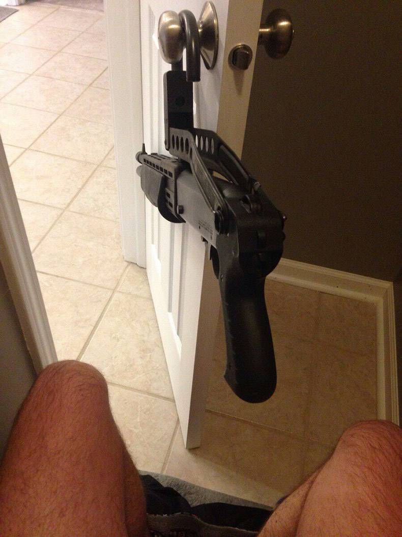 random pics - firearm hanging on bathroom door ready