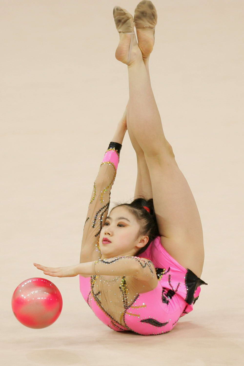 rhythmic gymnastics woman bent backwards bouncing ball