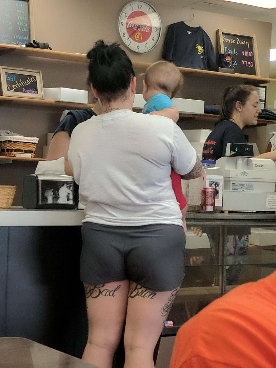 woman with tattoos on legs that say bad bitch
