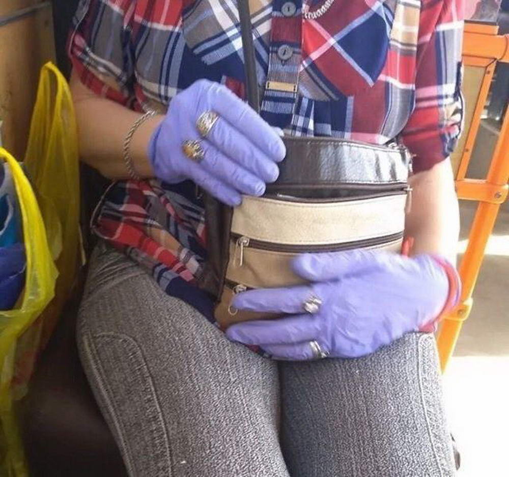 woman wearing rings and jewelry outside of her latex gloves