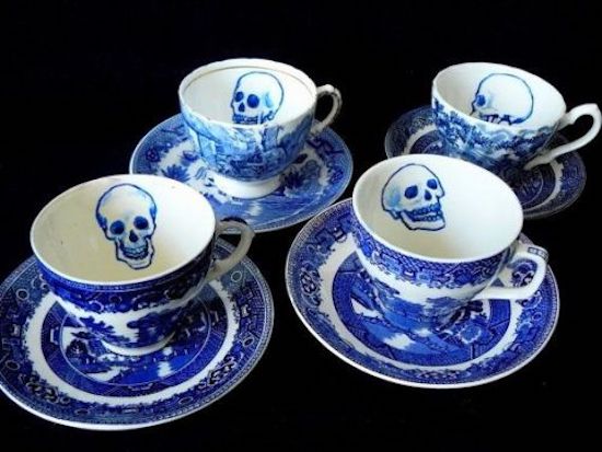 fine china saucers with skull drawings on the inside