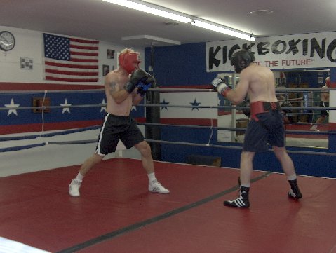 Me in some of my boxing action, June 2006, Sugar Grove, Illinois.
Me with red head gear and black trunks.
