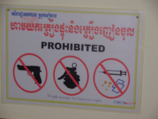How you know you're staying in a dump hotel...Sign that warns 'no grenades, guns or syringes'. 