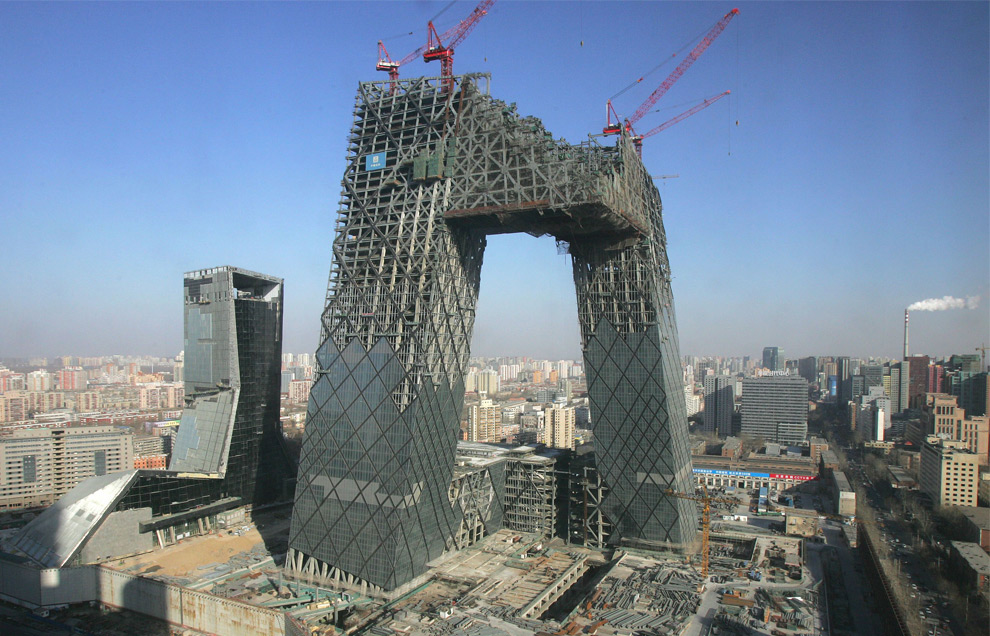 In this Jan. 23, 2008, the construction site of the new China Central Television headquarters building is seen in Beijing. The building's two angled towers were connected in December to form a continuous loop of horizontal and vertical sections. The 230 meter (755 foot) building, one of Beijing's tallest, houses more than 10,000 staff. (AP Photo/Greg Baker) #