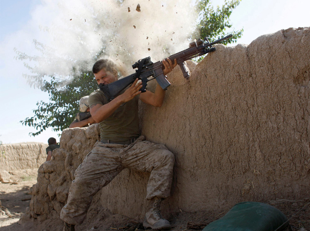 A U.S. Marine, from the 24th Marine Expeditionary Unit, has a close call after Taliban fighters opened fire near Garmser in Helmand Province of Afghanistan May 18, 2008. The Marine was not injured. (REUTERS/Goran Tomasevic) #
