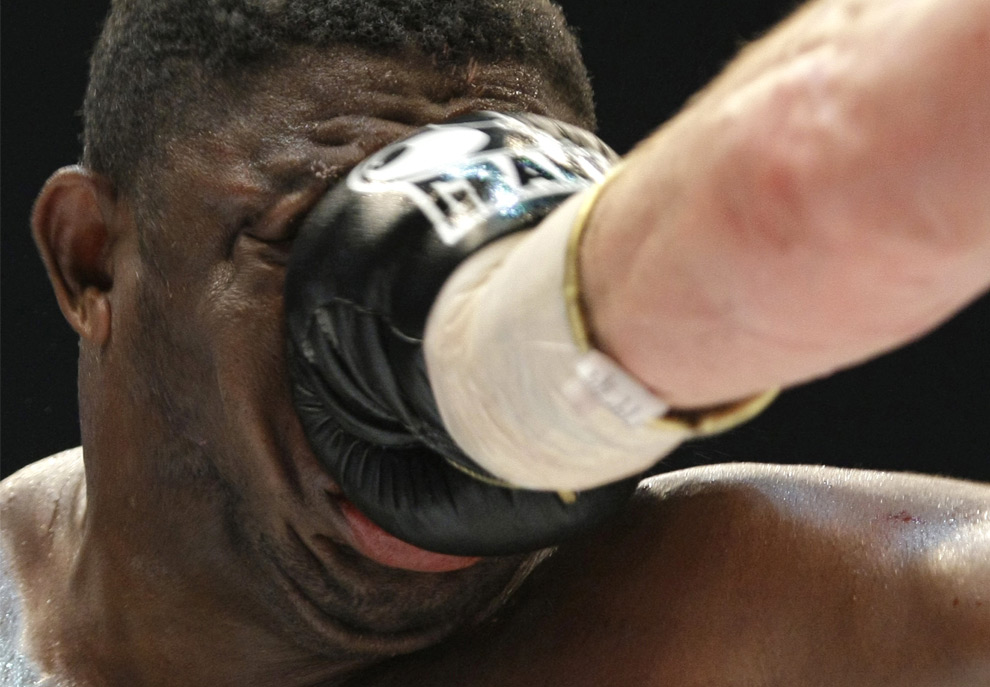 Samuel Peter from Nigeria receives a punch from Vitali Klitschko of Ukraine during their WBC heavyweight boxing world championship fight in Berlin, Germany on Oct. 11, 2008. Klitschko won the fight after round nine due to technical knock out. (AP Photo/Herbert Knosowski) #