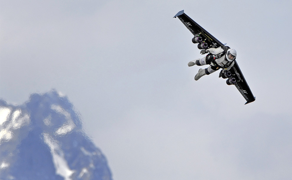 Swiss pilot Yves Rossy, the world's first man to fly with a jet-powered fixed-wing apparatus strapped to his back, flies during his first official demonstration, on May 14, 2008 above Bex, Switzerland. (Fabrice Coffrini/AFP/Getty Images) #