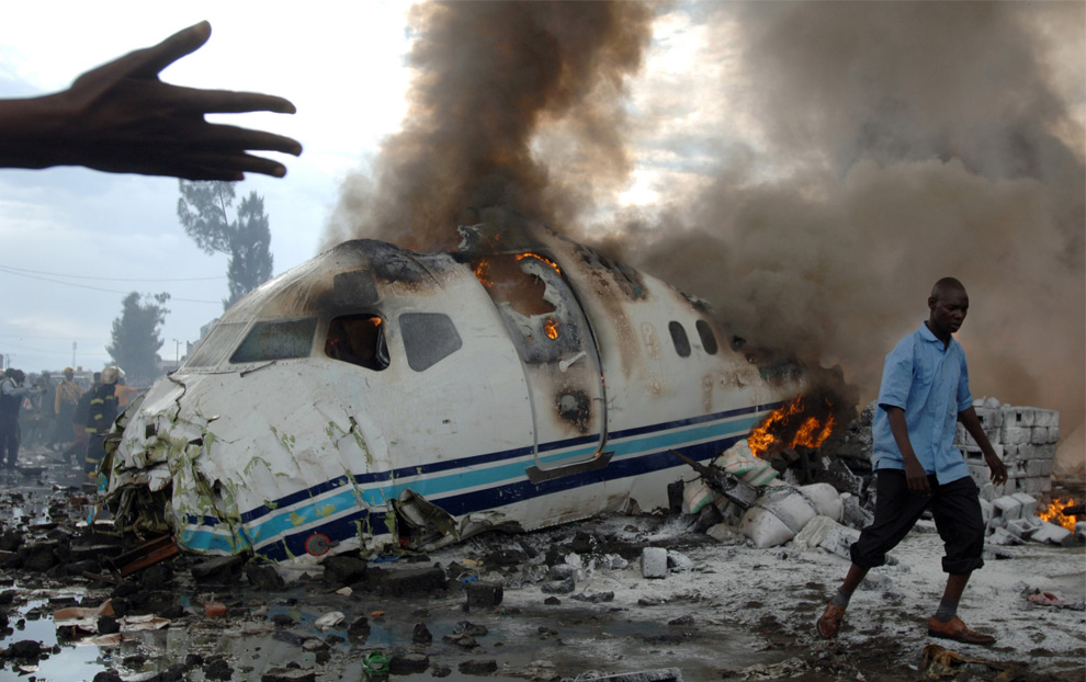 Flames from a wreckage of a passenger plane are seen after crash Goma in the east of the Democratic Republic of Congo on April 15, 2008. 40 people were killed, most of them were on the ground in the marketplace where the plane crashed. (Lionel Healing/AFP/Getty Images) #