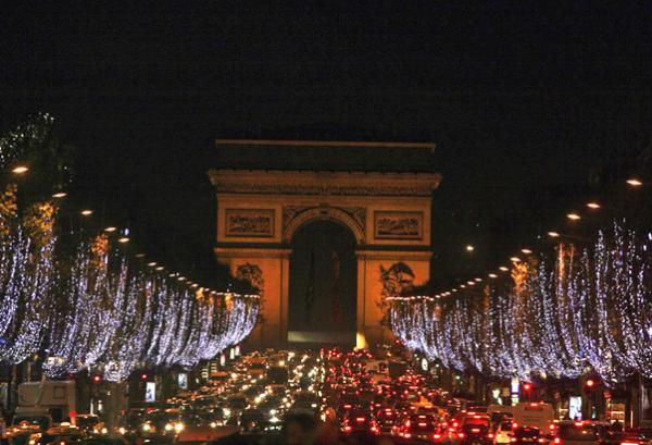  Christmas decorations light up the Champs Elysees avenue in Paris, Monday, Dec. 1, 2008, as the Arc de Triomphe is seen in the background. The decorations are traditionally put up late November each year for Christmas. (AP Photo/Muhammed Muheisen) 