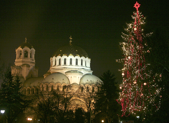  People walk past Christmas lights and tree in front of golden domed Alexander Nevski cathedral in the Bulgarian capital Sofia, Tuesday, Dec. 2, 2008. (AP Photo/Petar Petrov) 