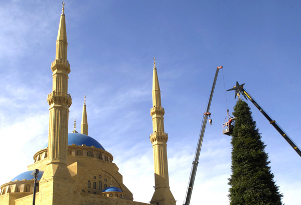  A crane lowers a star atop a giant Christmas tree near the Mohammad al-Amin Mosque in Beirut, Lebanon, Thursday, Dec. 4, 2008. (AP Photo/Ahmad Omar) 