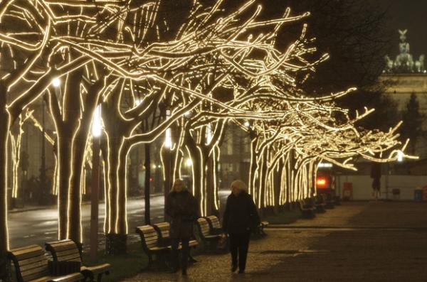  The "Unter den Linden" boulevard is illuminated with fairy lights as Christmas approaches in Berlin on Wednesday, Nov. 26, 2008. The background shows the landmark Brandenburg Gate. (AP Photo/Miguel Villagran) 