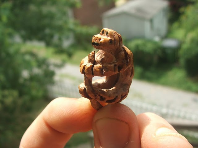 Monkey carved out of a peach seed...