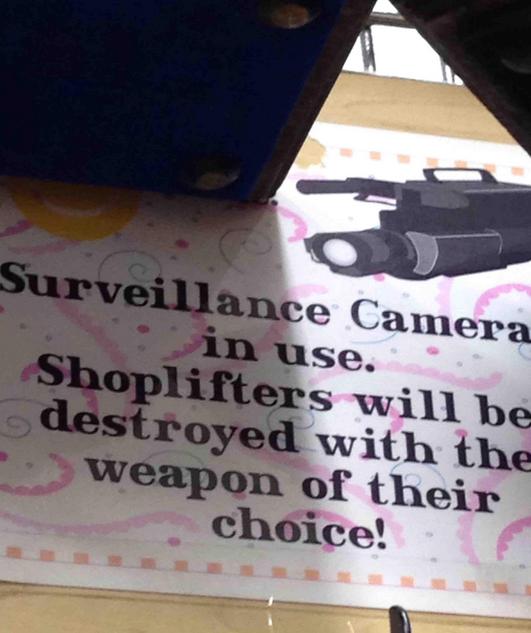 banner - Surveillance Camera in use. Shoplifters will be destroyed with the weapon of their choice!