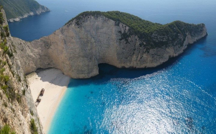 Navagio Beach, Greece - The beach is also known as Smugglers Cove because of the 163-foot long shipwrecked boat right in the middle of it, which was suspected to be a smuggling boat.