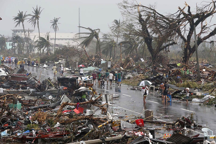 We're seeing more super typhoons... Residents walk on a road littered with debris after Super Typhoon Haiyan battered Tacloban city in central Philippines.