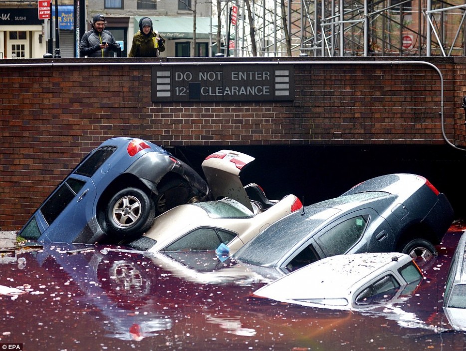 Cars lie half-submerged in a flooded parking lot after Hurricane Sandy hit New York