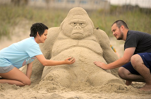 Savannah College of Art and Design students Chennon Roberts left and Josh Bean work on a gorilla sand sculpture during the 2014 SCAD Sand Arts Festival in Tybee Island, Georgia, May 2, 2014.