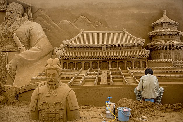 Sand sculptor Zhang Weikang of China works on the Chinese section of a large sand sculpture at the site of Yokohama Sand Art Exhibition - Culture City of East Asia 2014 on July 16, 2014 in Yokohama, Japan.