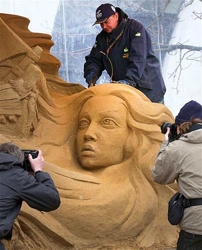 Sergey Tselebrovsky from Russia works on his sand sculpture ''In power of wind and water'' at a bathing area at the Baltic Sea in Warnemuende, Germany, April 5, 2013. Nine artists from six countries designed sand sculptures for the 4th Sand World exhibition with the theme "Fairy Tales and Myths of the Sea."