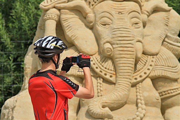 A man takes a picture of the sand sculpture ''Ganesh'' during the sand festival in Lednice, south Moravia, Czech Republic, June 19, 2014.