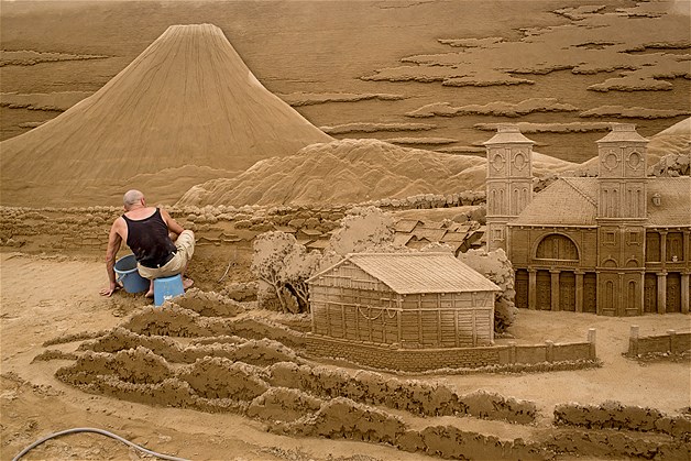 Sand sculptor Leonardo Ugolini of Italy works on a a section showing small Japanese villages at the site of Yokohama Sand Art Exhibition - Culture City of East Asia 2014 on July 16, 2014 in Yokohama, Japan.