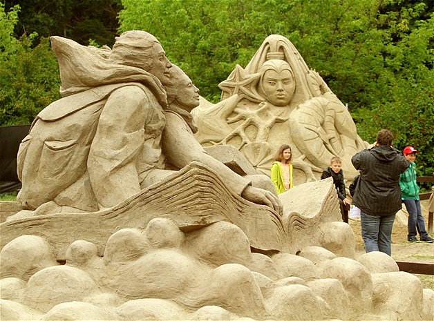 Visitors walk past sand sculptures on display at the International Sand Sculptures Festival in Palanga, Lithuania, July 14, 2014.