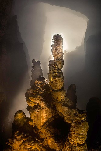A caver stands near the entrance of the Hang Son Doong cave in Quang Binh Province, Vietnam.