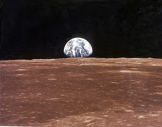 This view of the rising Earth greeted the Apollo 11 astronauts as they came from behind the Moon after the lunar orbit insertion burn.