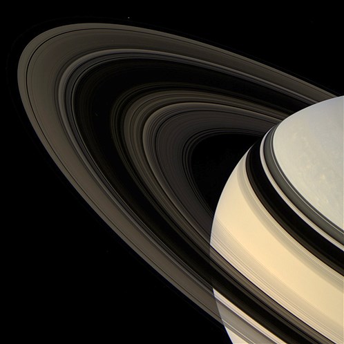 Colorful Saturn and its rings as photographed by the Cassini spacecraft. The F-ring shepherd moon Pandora is faintly visible at the top, left of center.