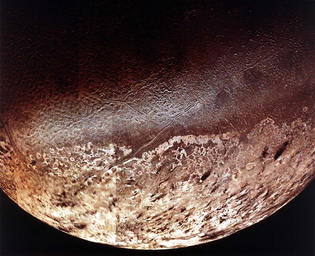 This photo of Neptune's satellite moon Triton was taken in 1989 by the only spacecraft ever to pass Triton: Voyager 2.
