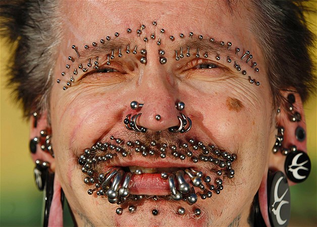 Guinness World Record holder for the ''Most Pierced Man,'' Rolf Bucholz of Germany, poses showing some of his 453 piercings in Dortmund, Germany, Oct. 24, 2011.