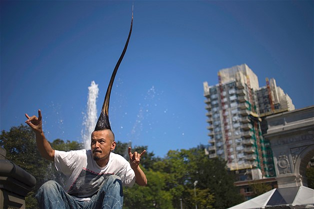 Japanese fashion designer Kazuhiro Watanabe, who holds the world record for the "Tallest Mohawk," poses for a photographer at a media event held by the Guinness World Records to launch their 2013 book edition in New York, Sept. 12, 2012. According to the Guinness World Records, Watanabe's do stands at 3 feet 8.6 inches and, presumably, growing.