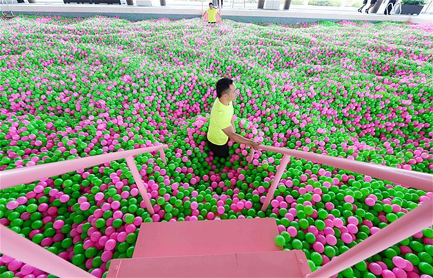 Kerry Hotel in Shanghai has set a new Guinness World Record by creating the world's largest ball pool. The hotel drained its 82-foot-long swimming pool and filled it instead with 1 million pink and green colored plastic balls. According to the hotel, the balls used in the record will now be sold and the money will be donated to Shanghai Cancer Recovery Club. As well as benefiting from the donation, members of the club also got to enjoy themselves in the giant ball pool.